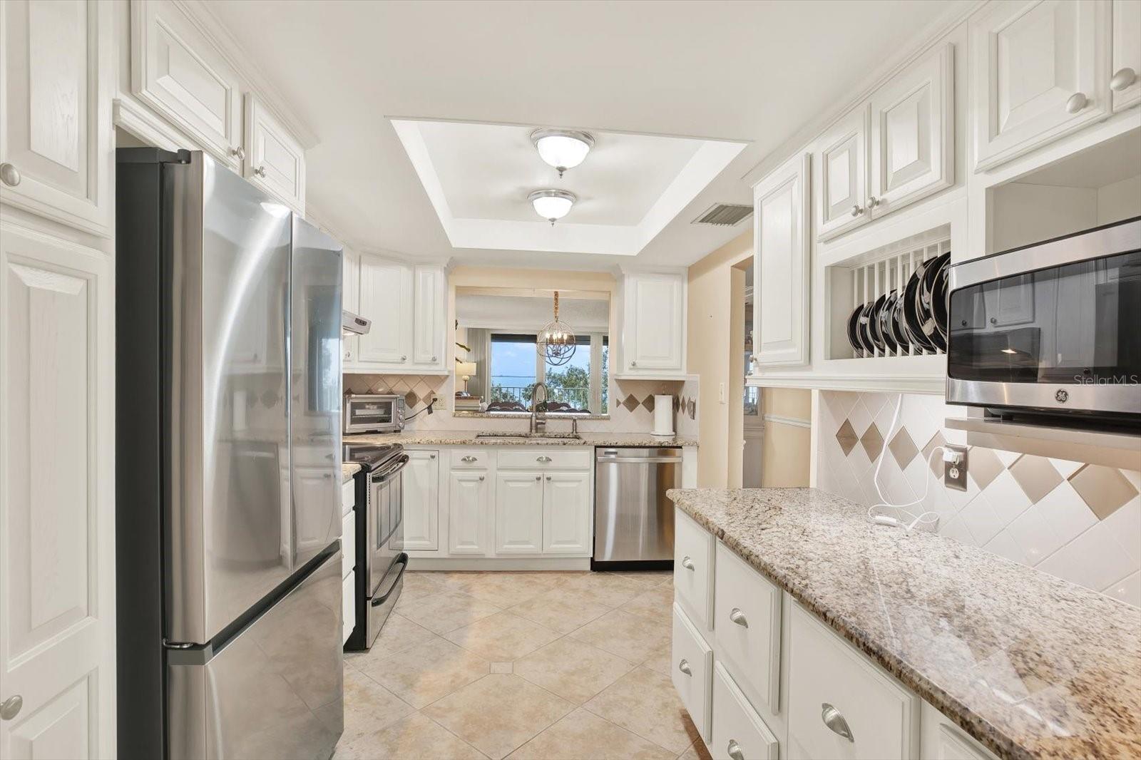 Custom cabinets with a plate holder and pull-out pantry drawers for easy access.