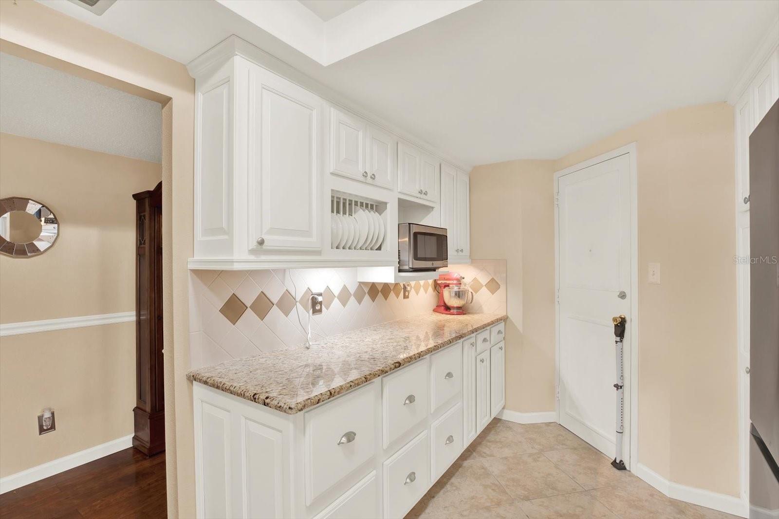 Ample cabinets and storage. Custom cabinets with plate holder and pull-out pantry drawers.
