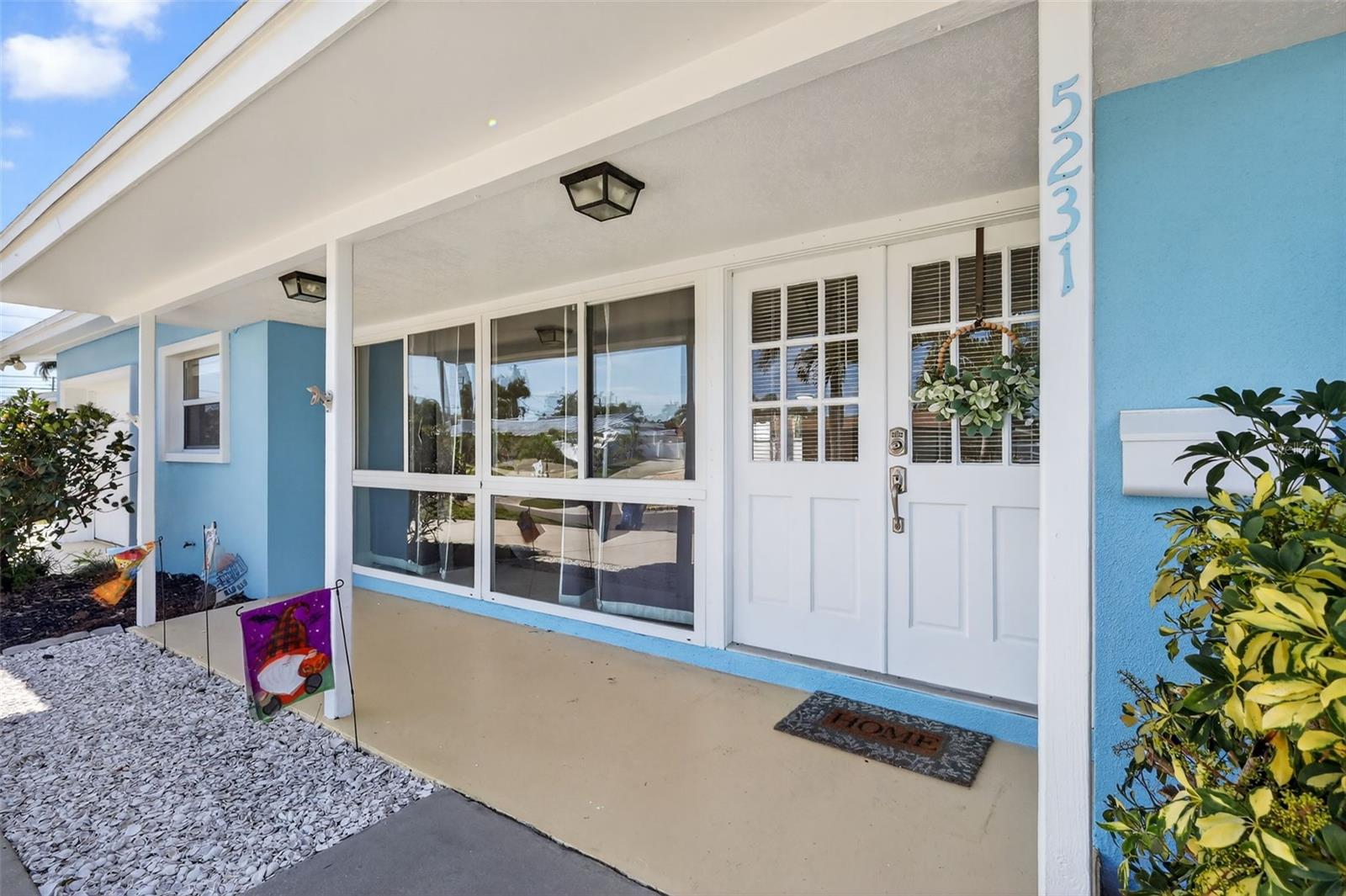 The front entry with double doors and large windows for an abundance of light