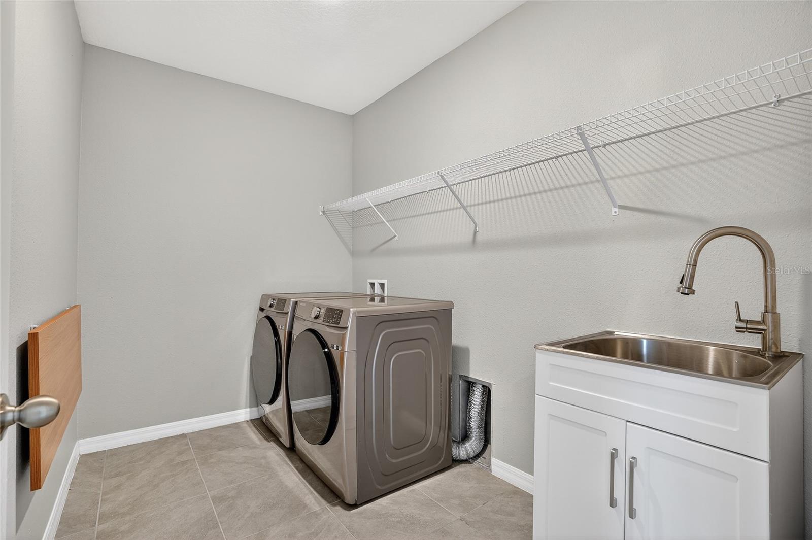 upstairs separate laundry room with sink