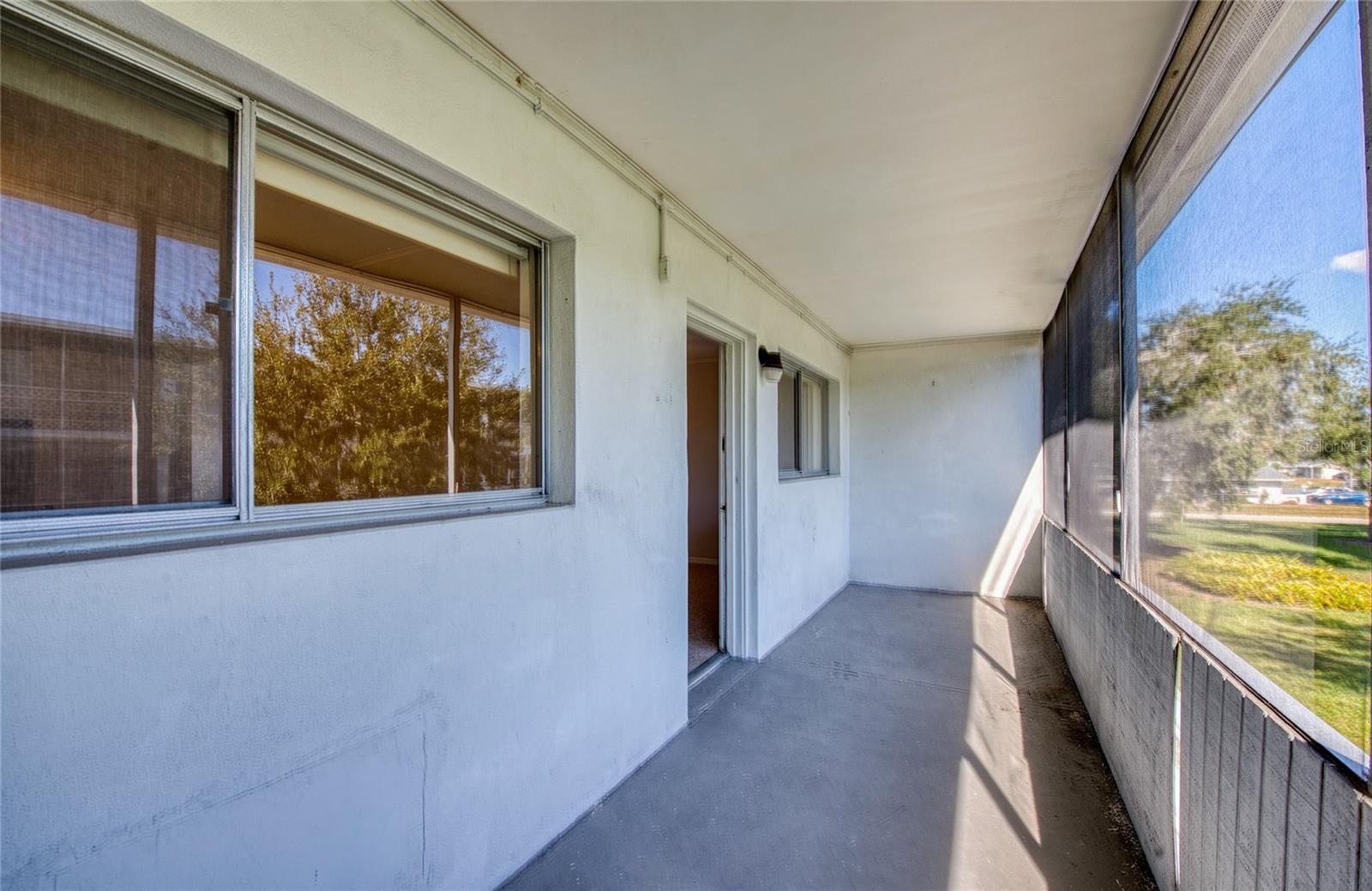 Screened-in porch with storage closet off of the