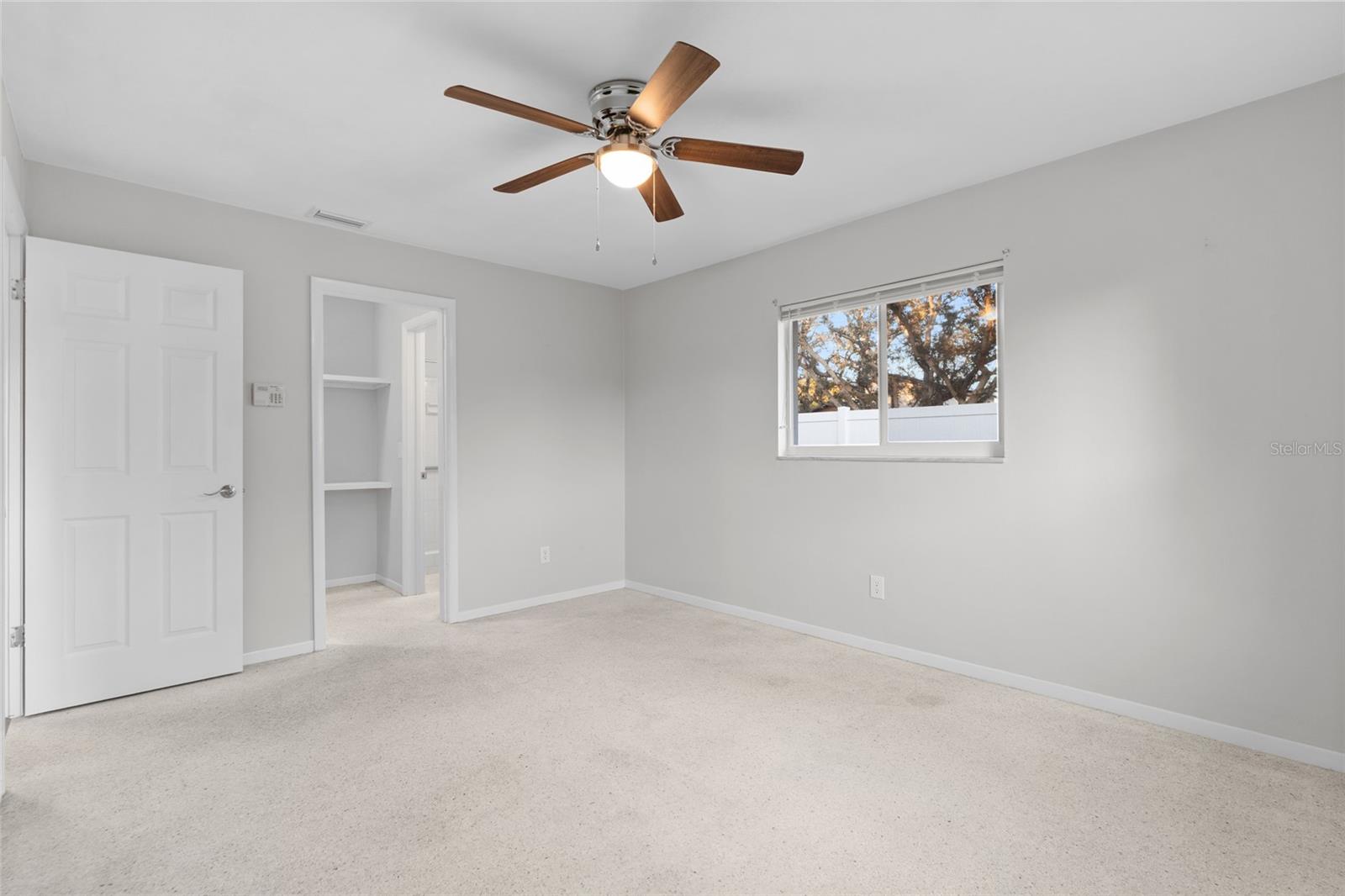 Primary bedroom with walk in closet and bathroom