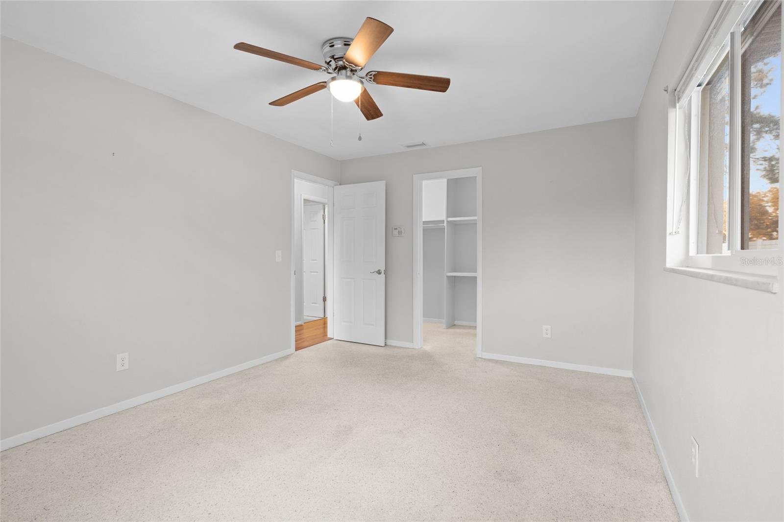 Primary bedroom with walk in closet and bathroom