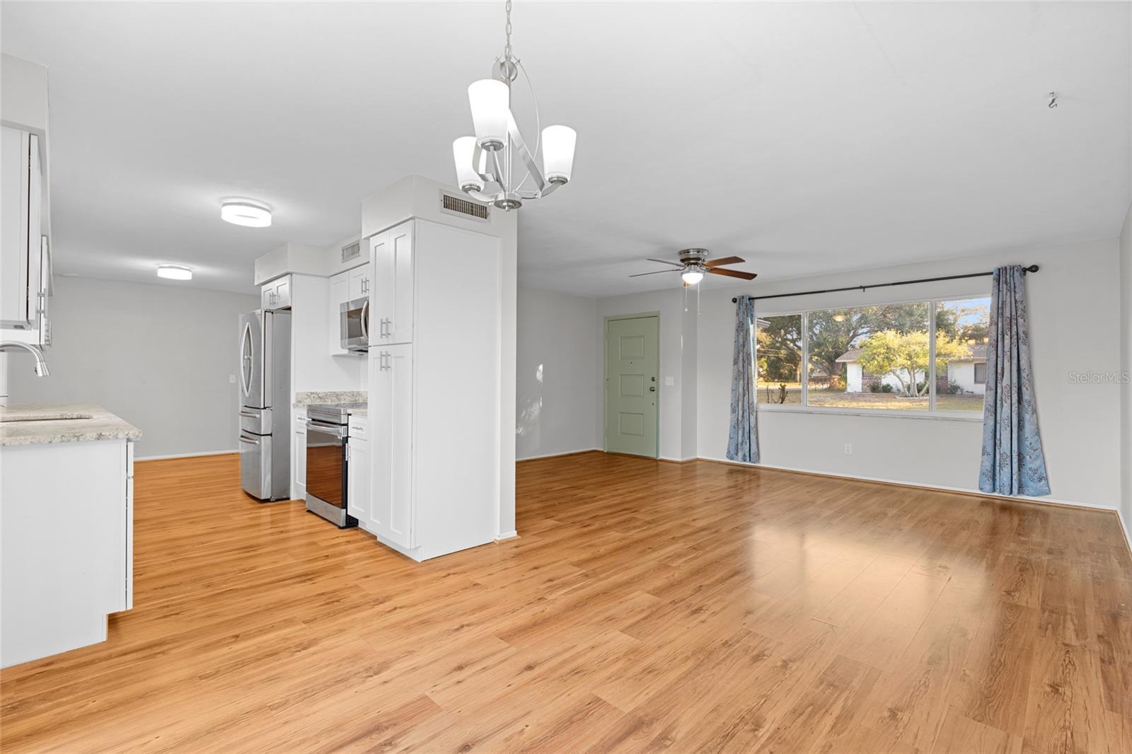 Open floor plan leads from living room, to dining area and into the kitchen