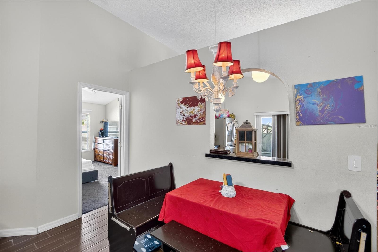 Dining Area.  Door to Owner's Suite to the left.  Kitchen arched pass thru in the middle.
