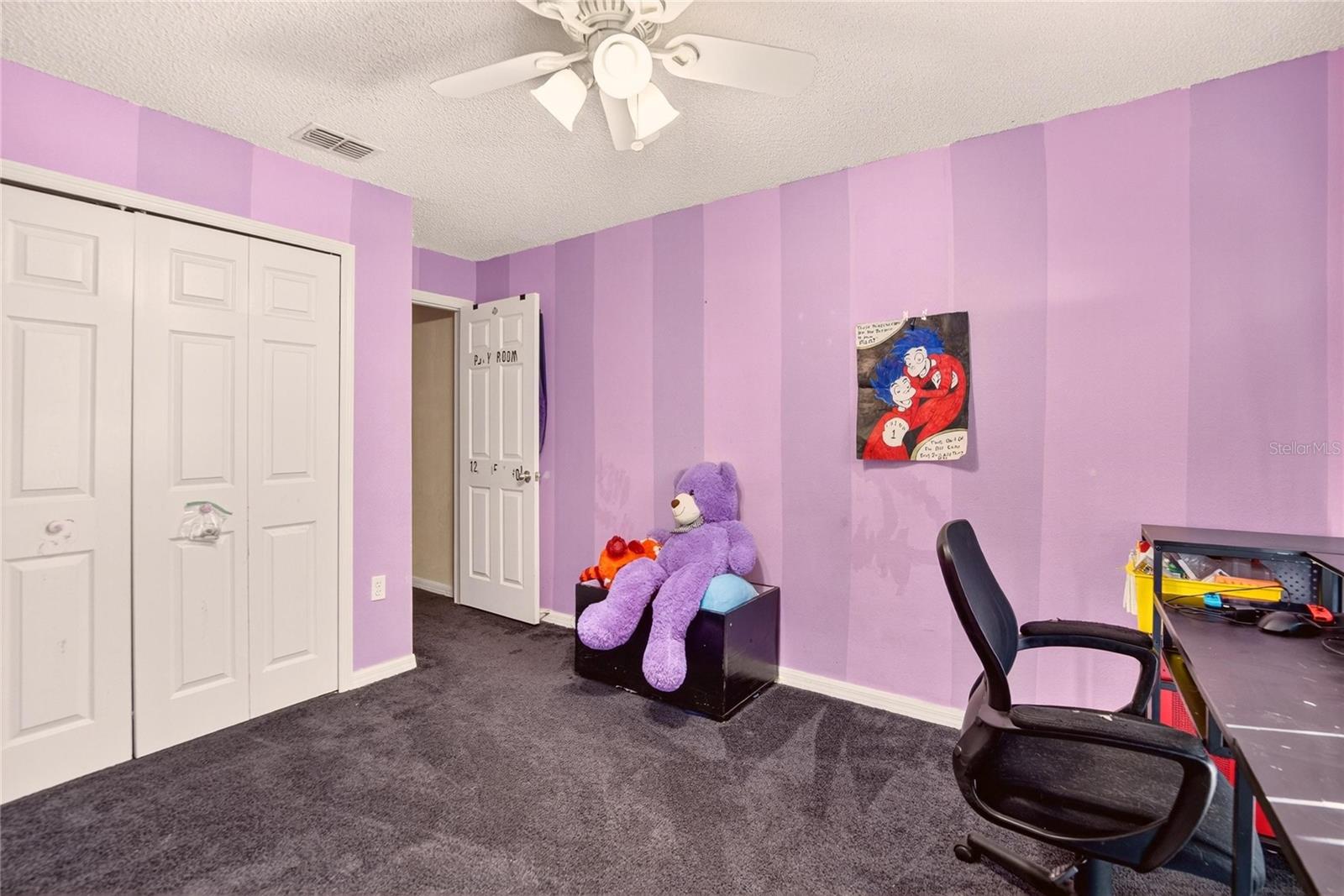 Secondary Bedroom #1 at the front of the house.  Door to hallway at center.