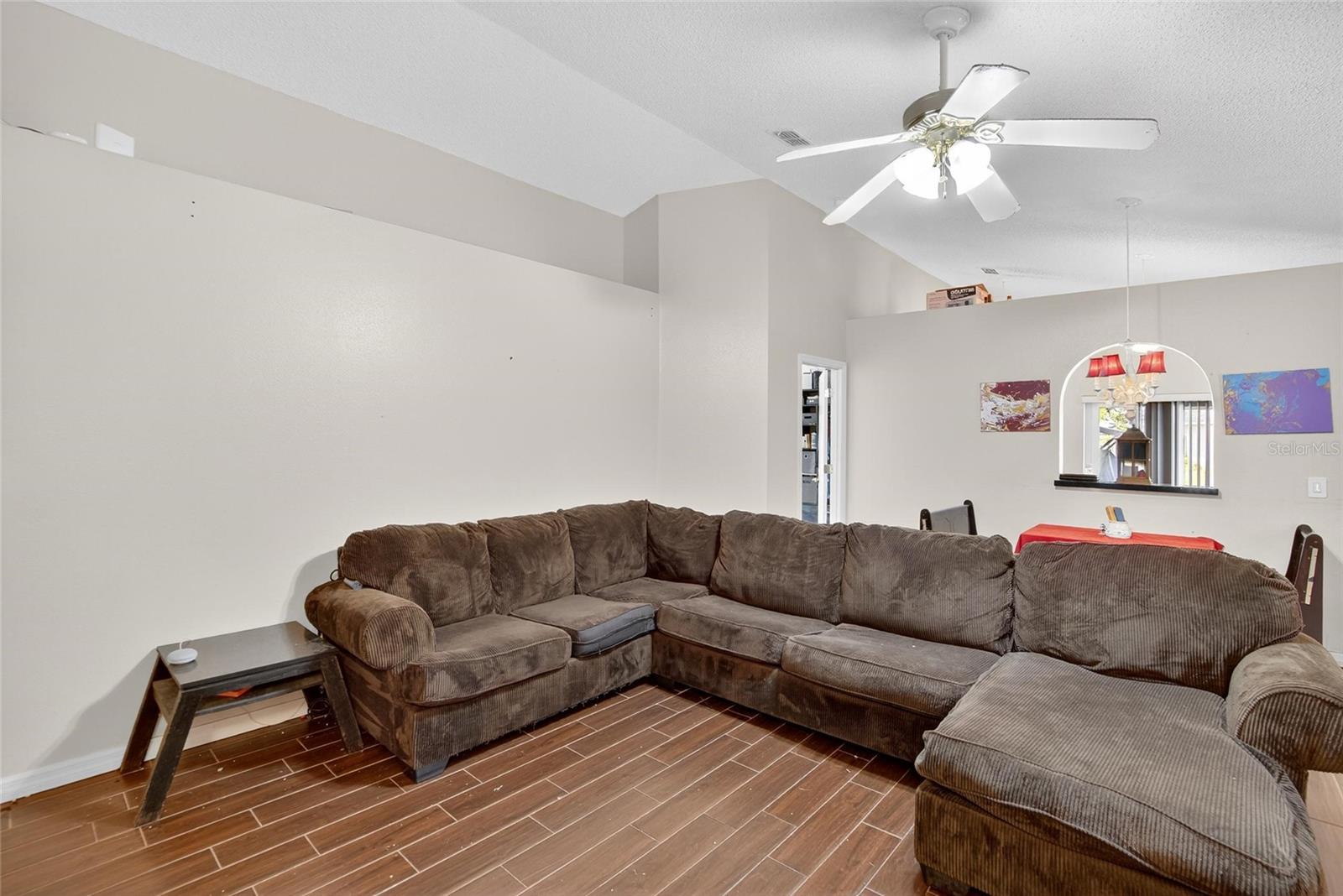 View of Family Room Dining Area Combo from entry door. Owner's Suite entry to the left. Kitchen through arched pass thru.