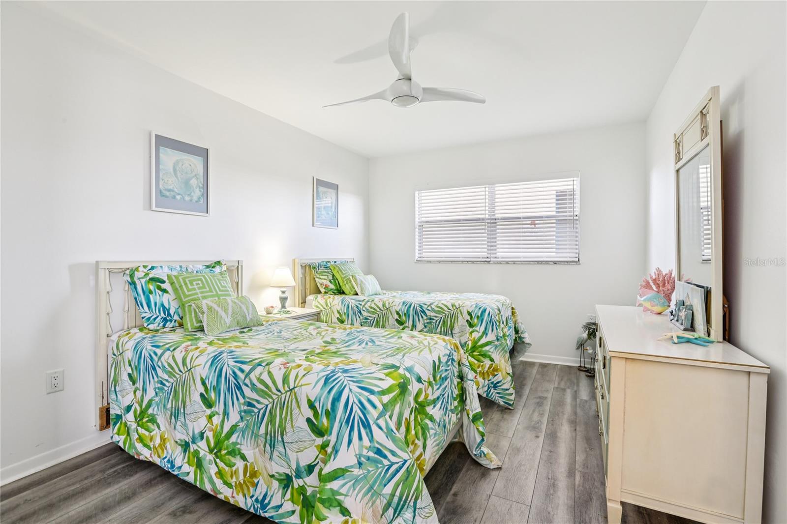 The second bedroom is spacious and inviting, featuring a window that fills the room with natural light.