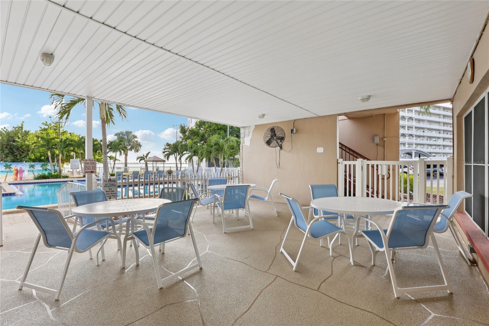 Enjoy the covered areas by the clubhouse pool—perfect for relaxing and catching up with friends in the shade.