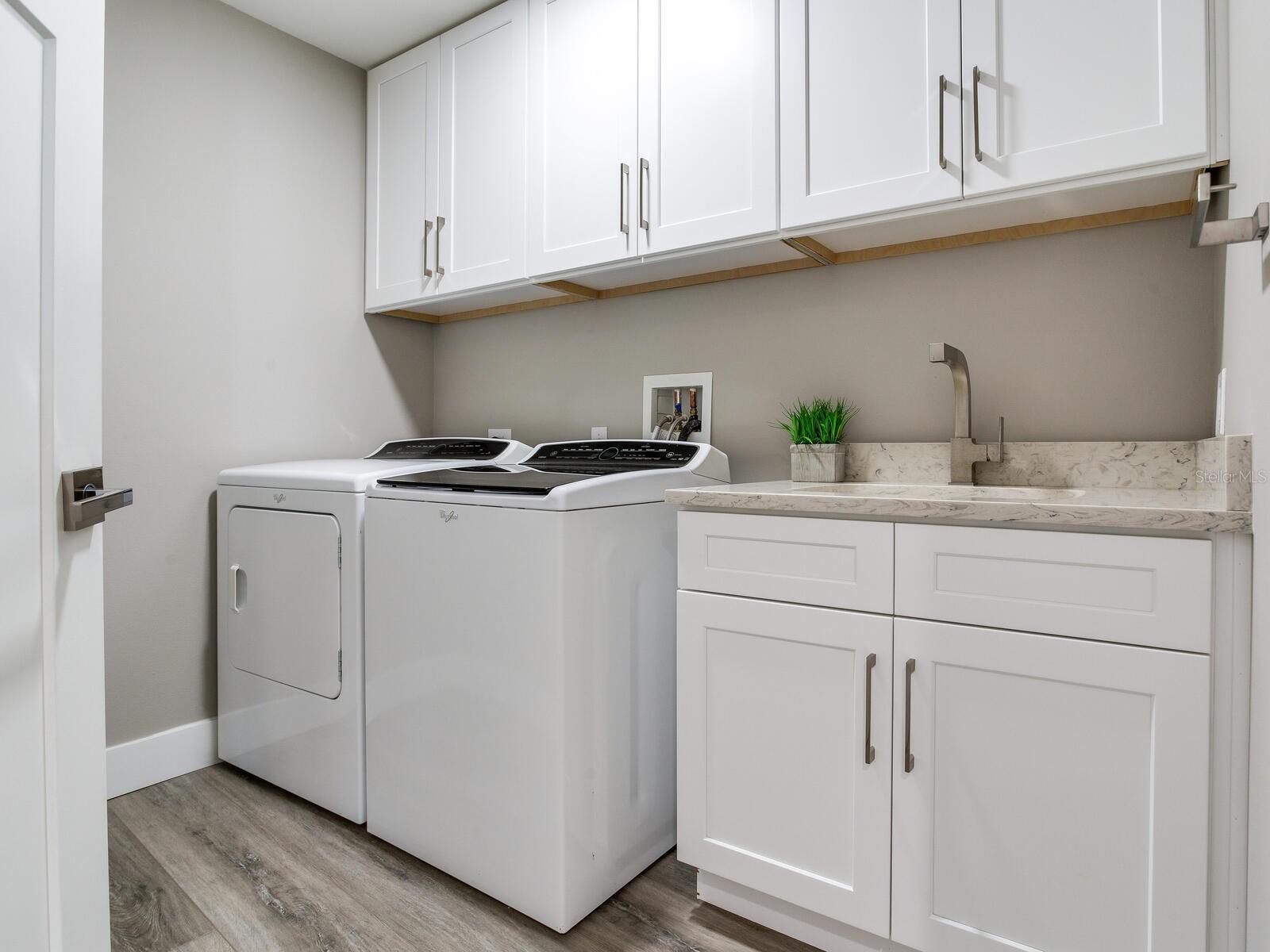 Laundry Room with Laundry sink and storage