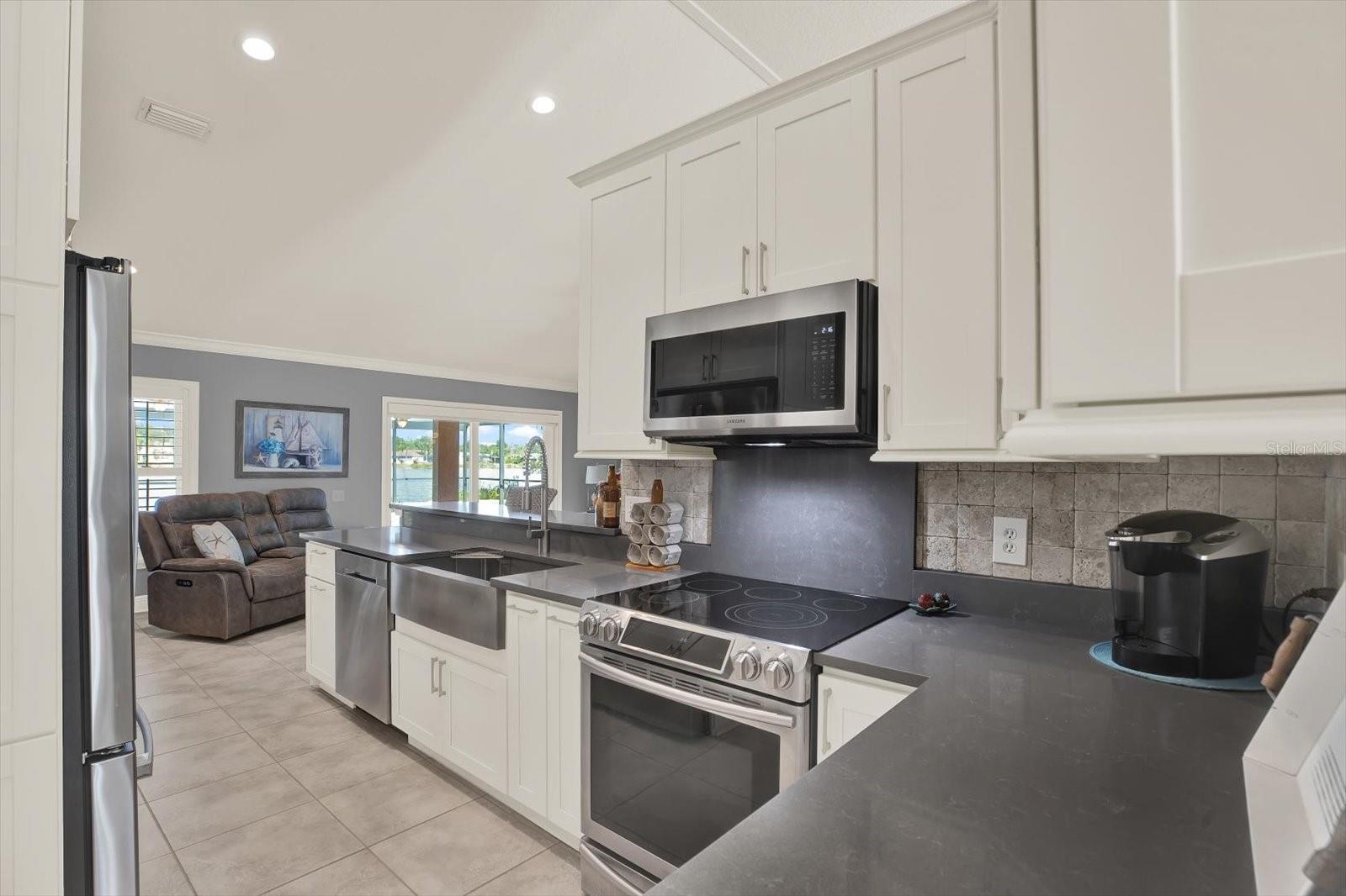 This kitchen is equipped with Samsung appliances, including a convection oven, soft-close cabinets, and modern Silstone countertops. Silestone not only looks elegant, but it is also low maintenance and durable. They are resistant to heat, scratches, and stains, while their non-porous nature offers hygienic, easy-to-clean surfaces.