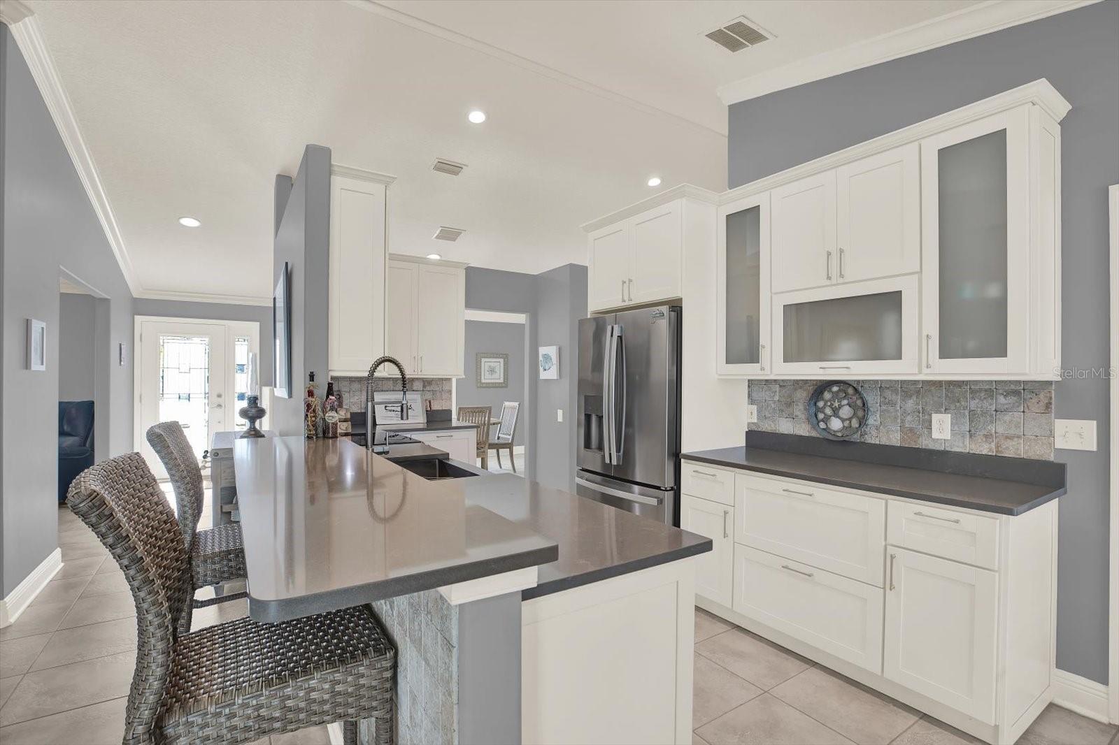 The soft-close cabinet doors feature smoked glass panels, giving the room additional stylish feature while not exposing all of the cabinet's contents.