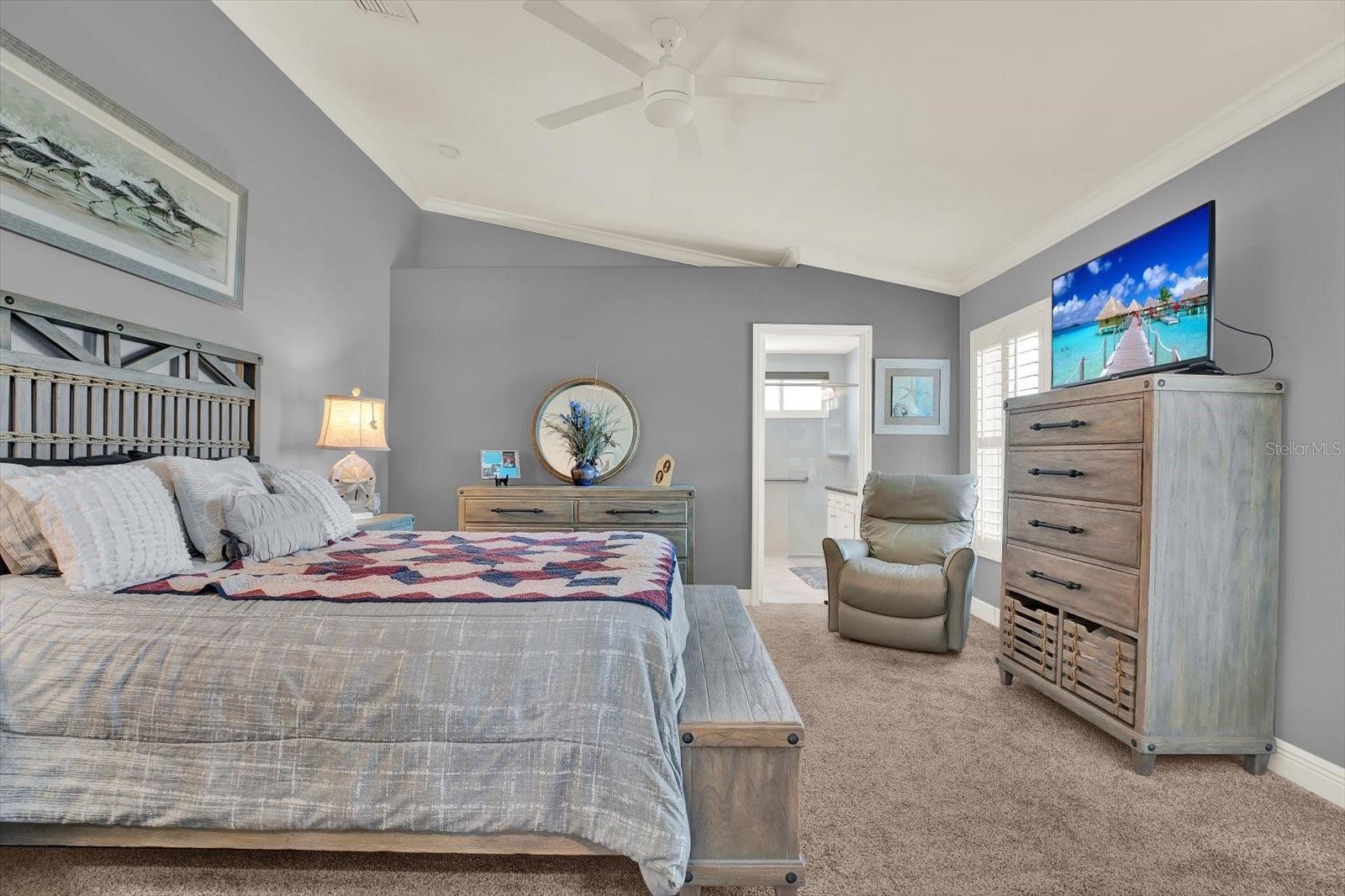 The high ceilings continue into the spacious primary suite.