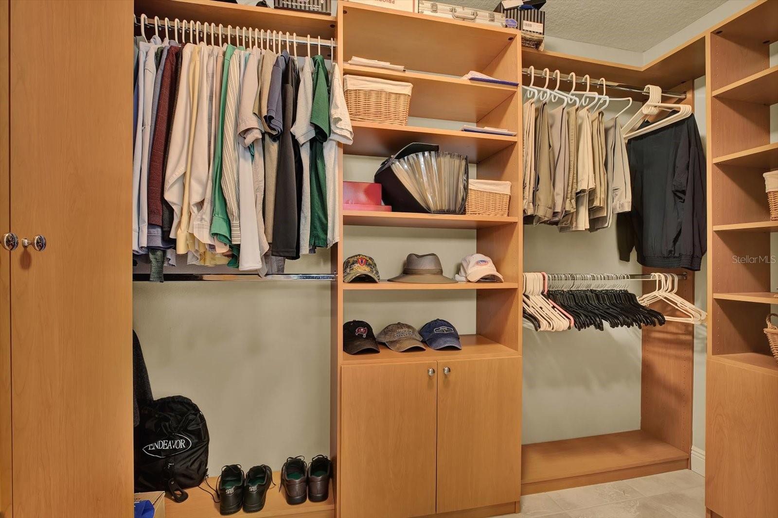 Passing through the primary bath and private toilet room, you enter an oversized walk-in closet with built-in custom cabinetry.