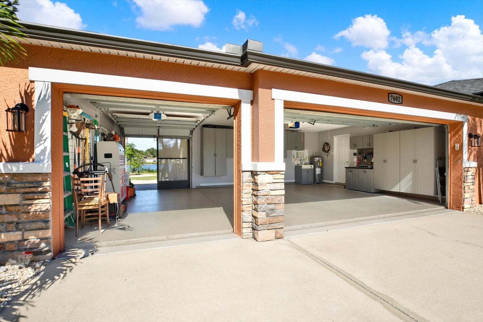 The upgrades and attention to detail are apparent from the moment you enter the property. The garage features a unique drive-through garage with built-in cabinetry, a wash sink, and polyaspartic-coated floors.