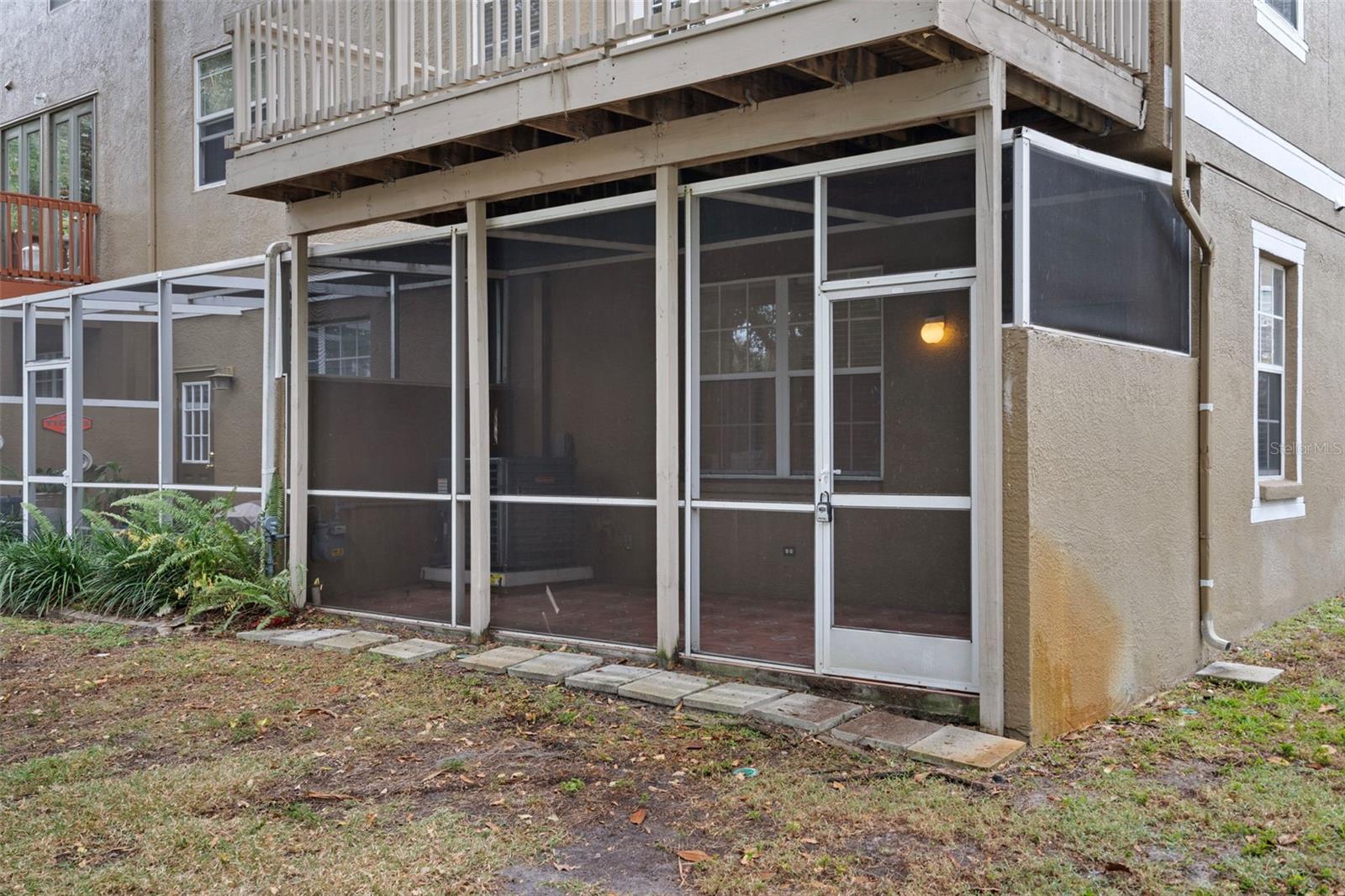 View of the screened in porch from the back of the home.