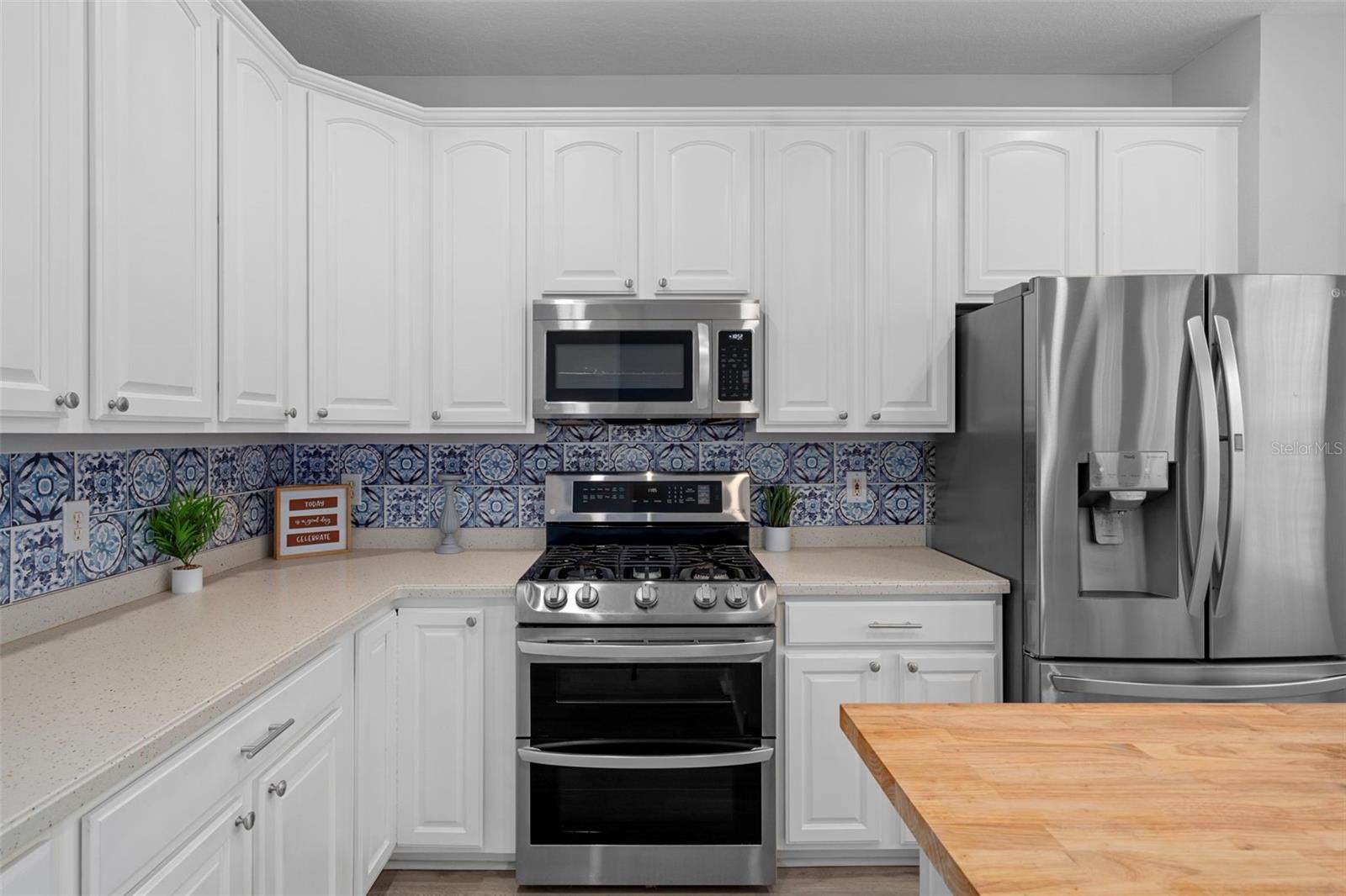 This kitchen has an abundance of cabinets and counter top space