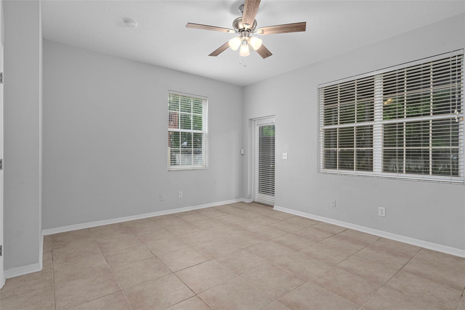 Bonus room with tiled floors, notice the door in the corner to the screened in porch