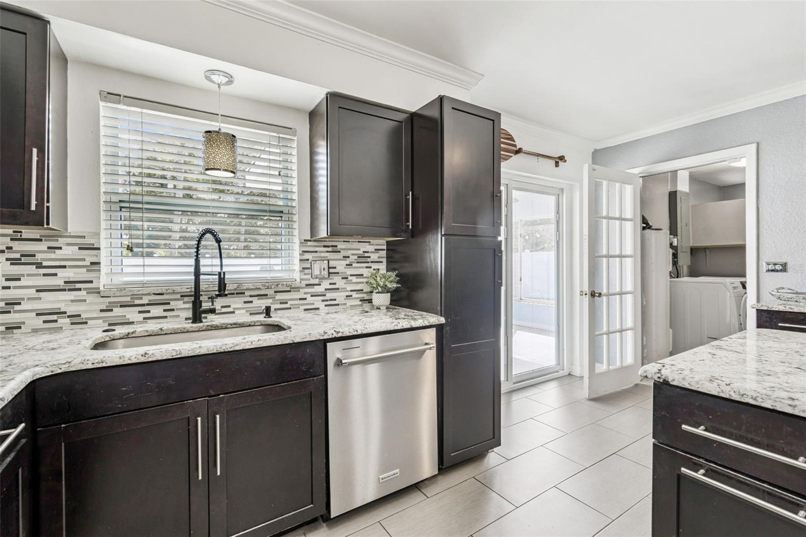 Laundry room is to the right through that open door. Sliders on rear leading to the Florida Room