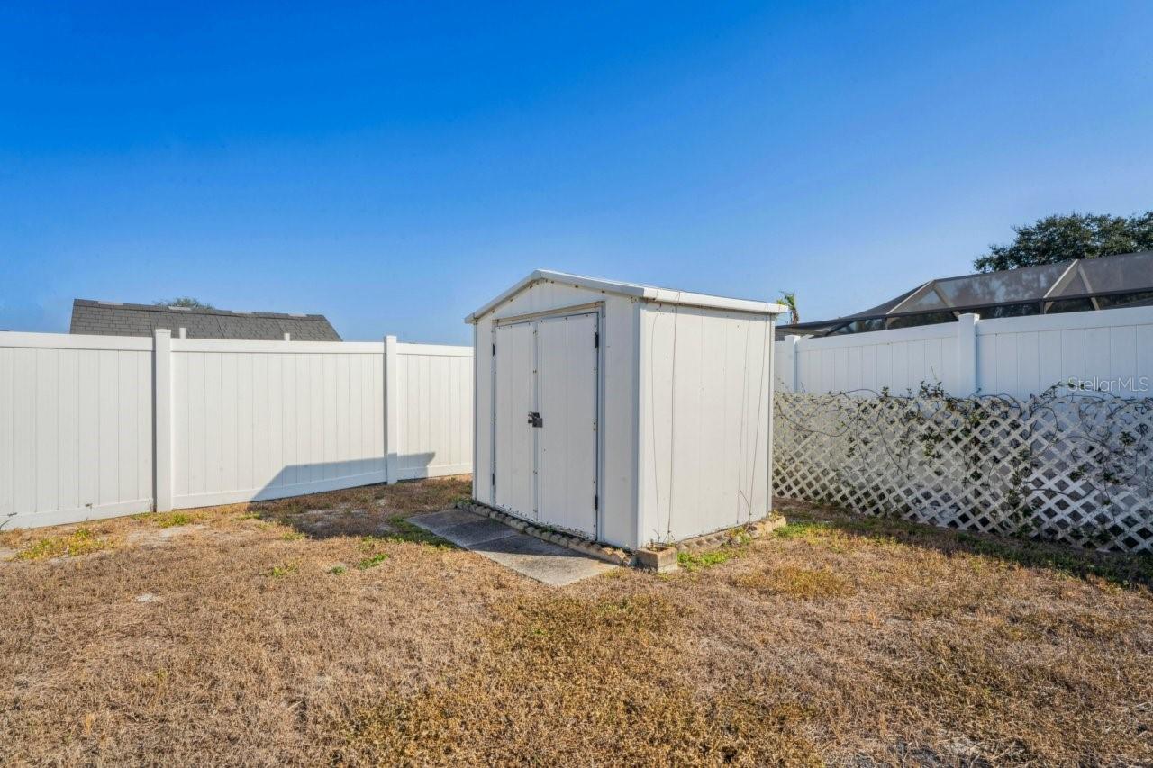 Shed for storage, partially fenced in yard