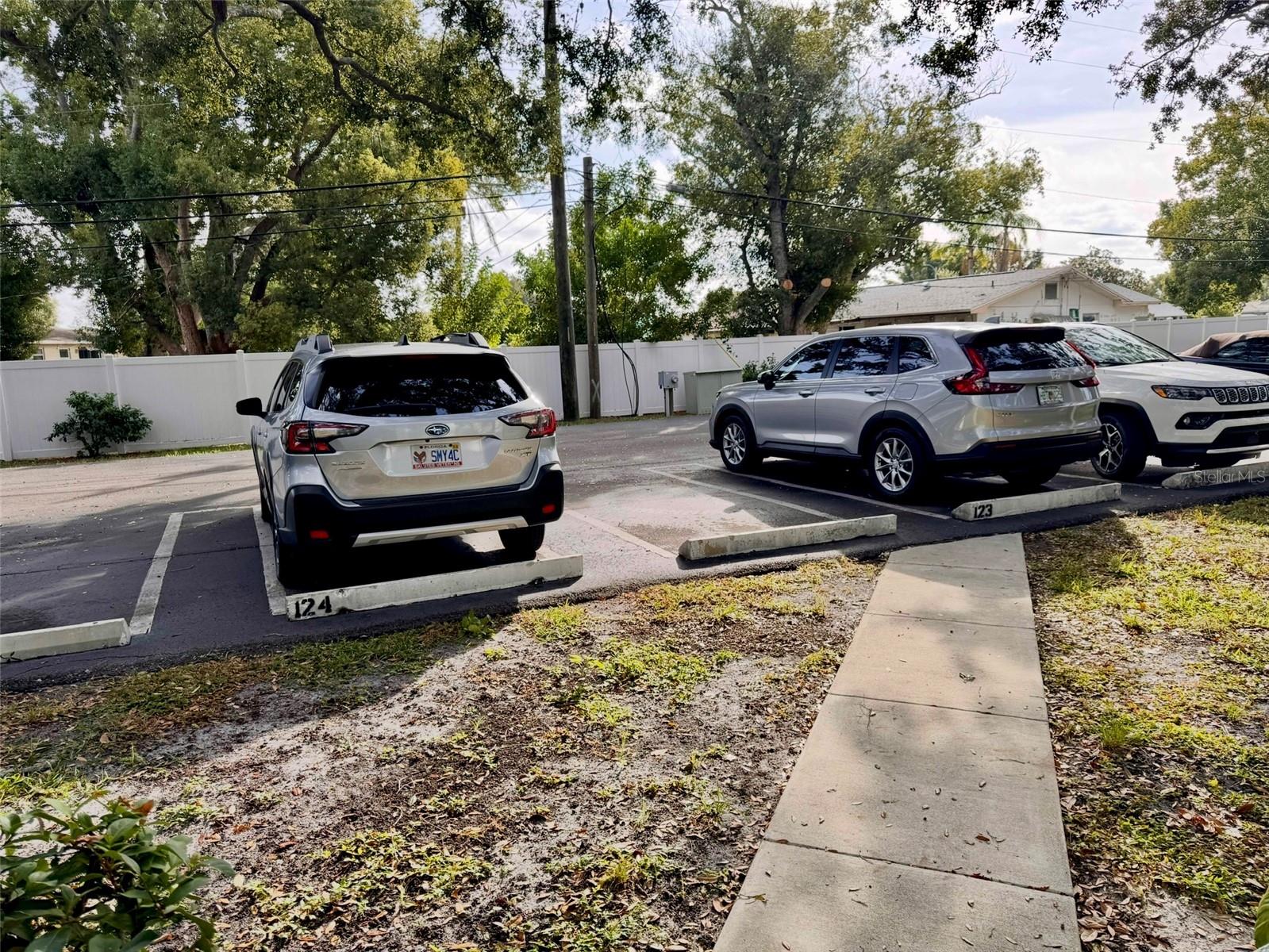 Parking spot 123 is conveniently located at the end of your sidewalk, just outside your front door. Guest parking on each side.