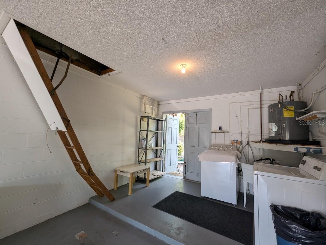 Garage with attic access and double doors, suitable for golf cart storage