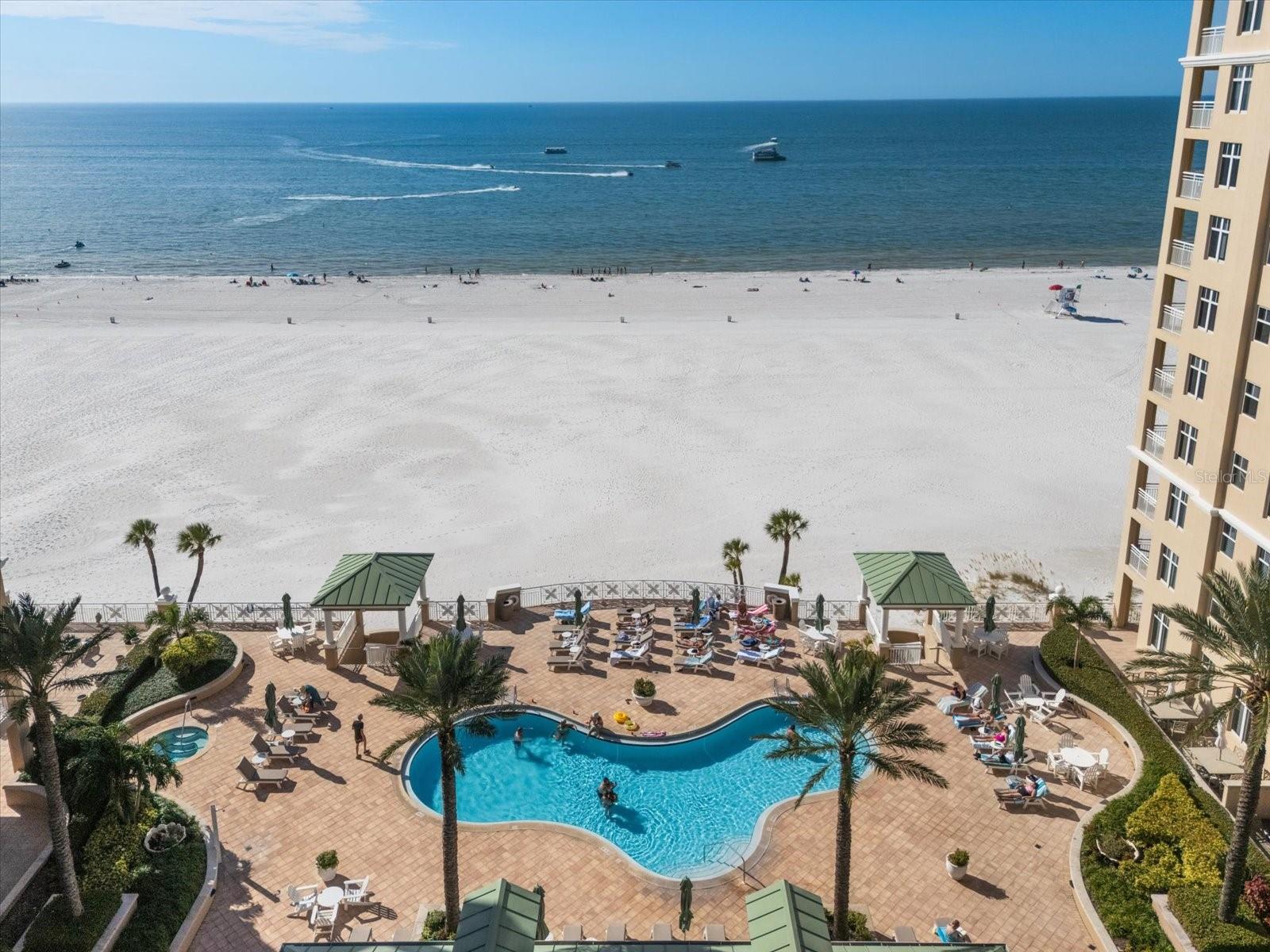 POOL W/ HOT TUB, TABLES W/ UMBRELLAS, CHAISE LOUNGES, GRILLING STATION