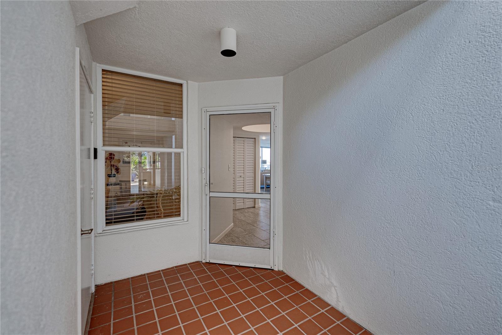 Unit’s front door - Entry area — very private — storage closet door on the left