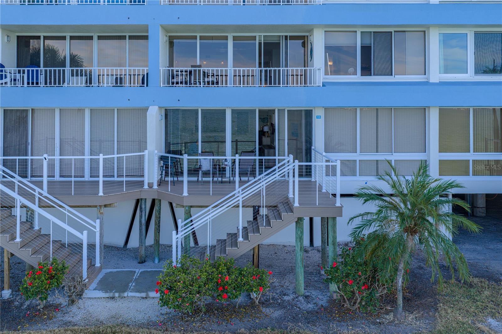 View of Exterior Rear Deck with access via staircase to ground level … walk to the pool!