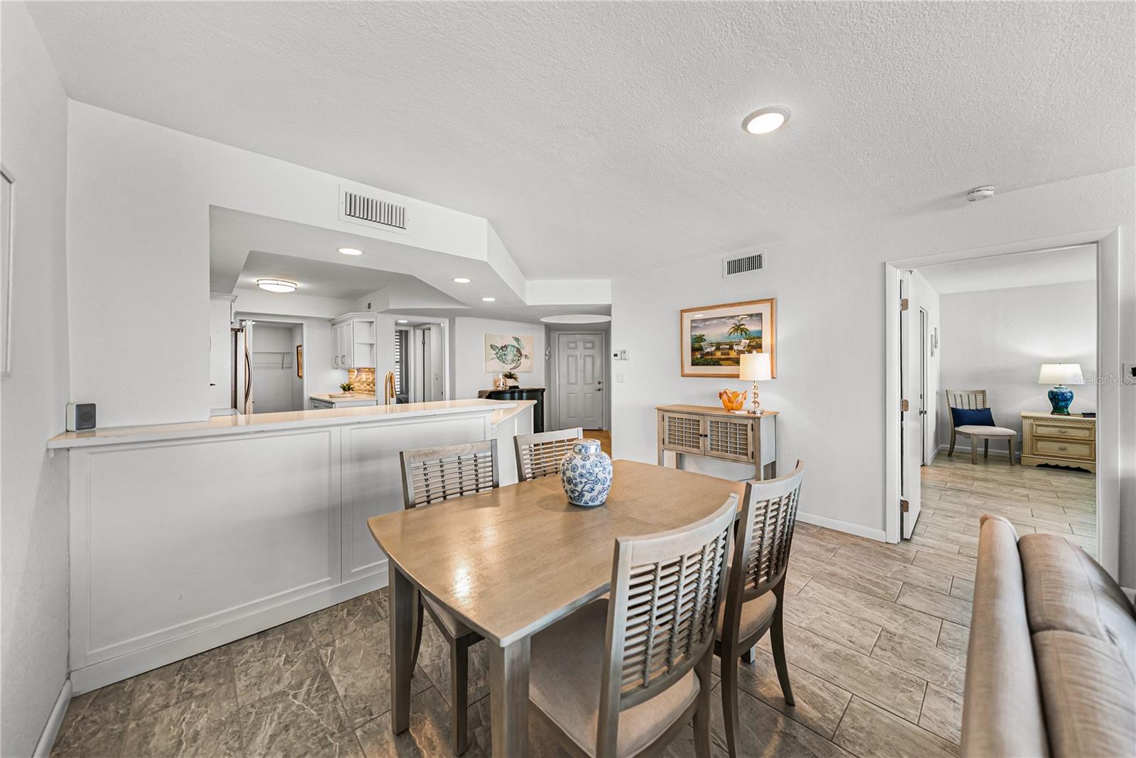 Dining room view to front door, primary suite, kitchen and guest en-suite