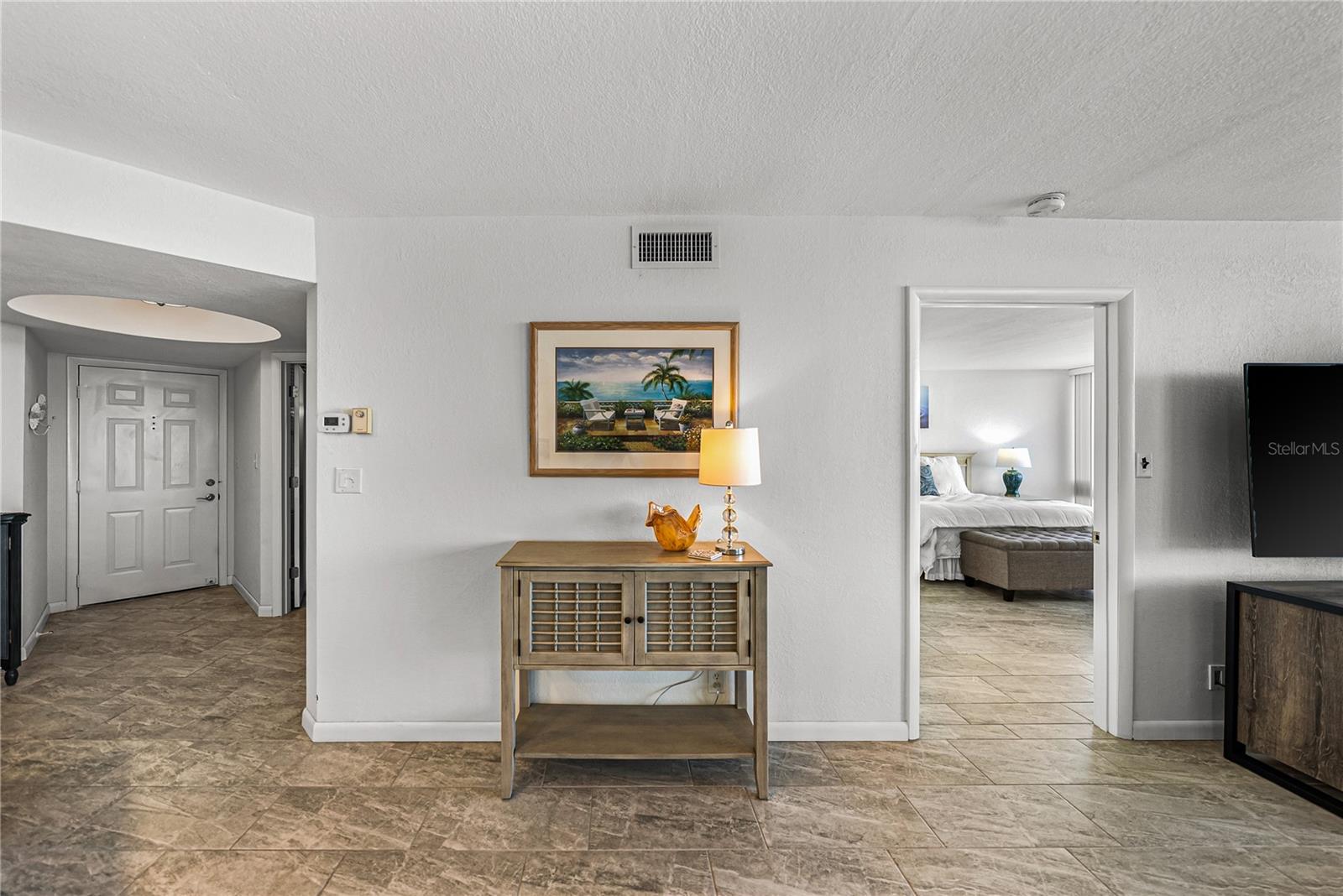 View from Dining Area to Front door and Primary Suite