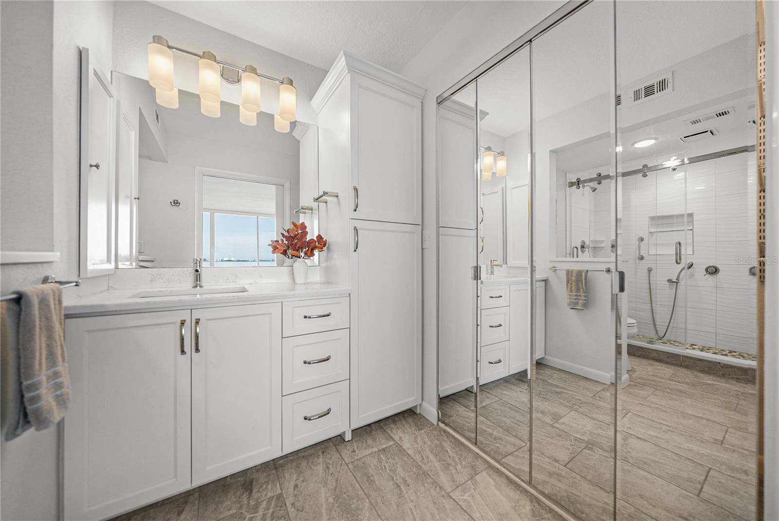 Primary bath — much cabinetry with walk-in closet