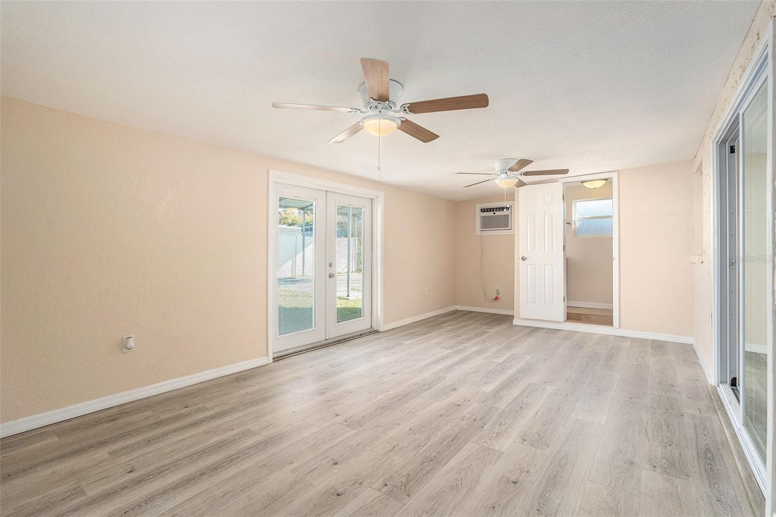 Large bonus room with half bath leading to backyard