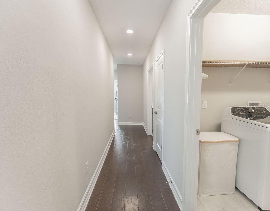 The third-floor hallway includes convenient access to the laundry room.