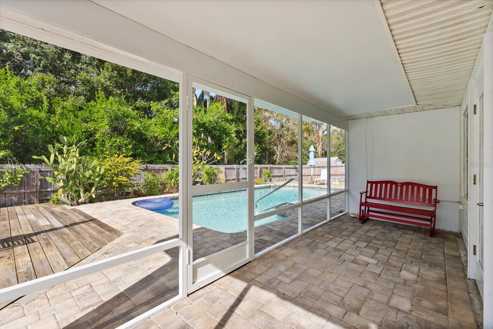 Screen enclosed porch with brick pavers