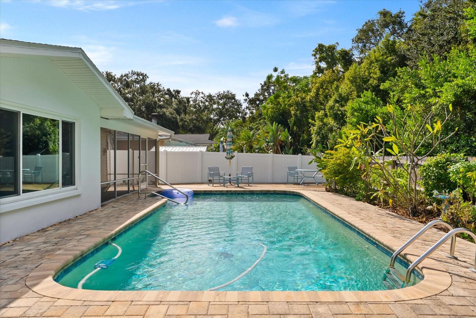 Brick pavers surround the sparkling pool