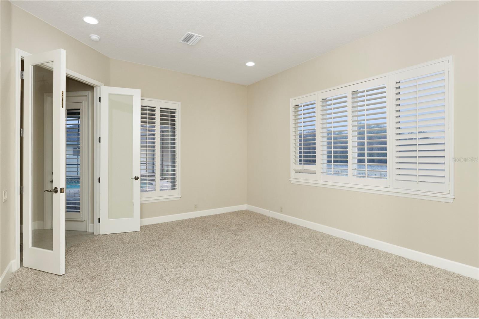 Bonus Room with plantations shutters and double glass doors
