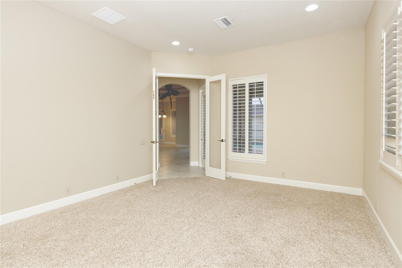 Bonus Room with plantations shutters and double glass doors