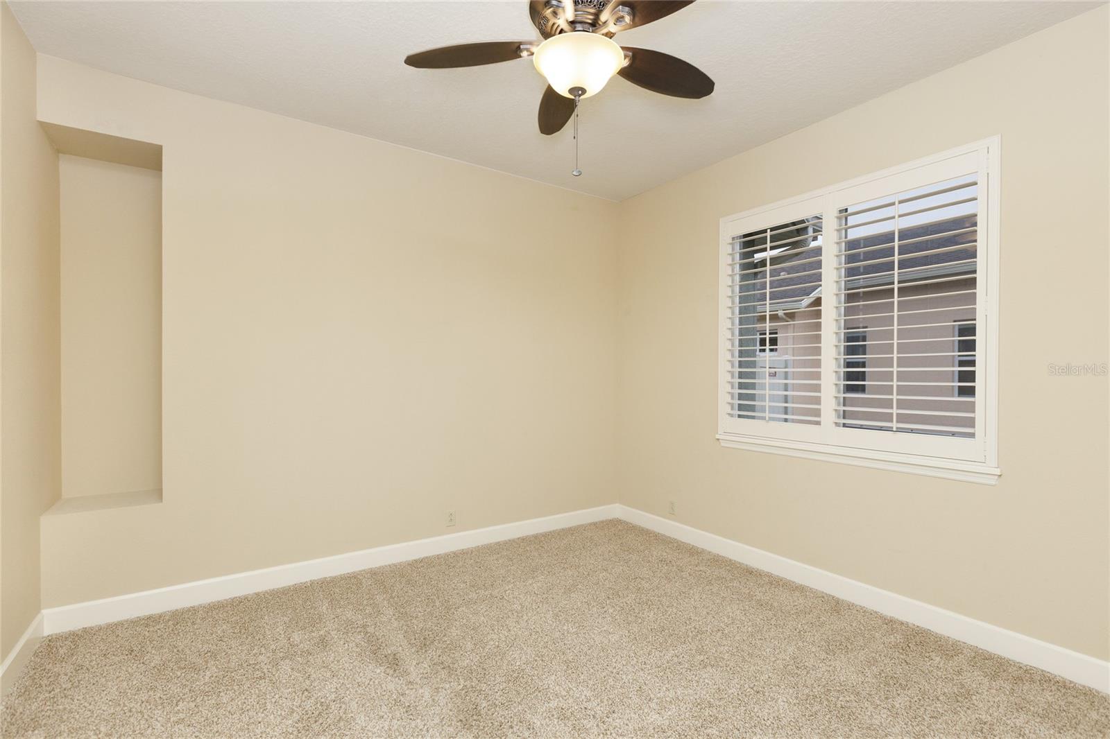 Bedroom 4 with plantation shutters and ceiling fan