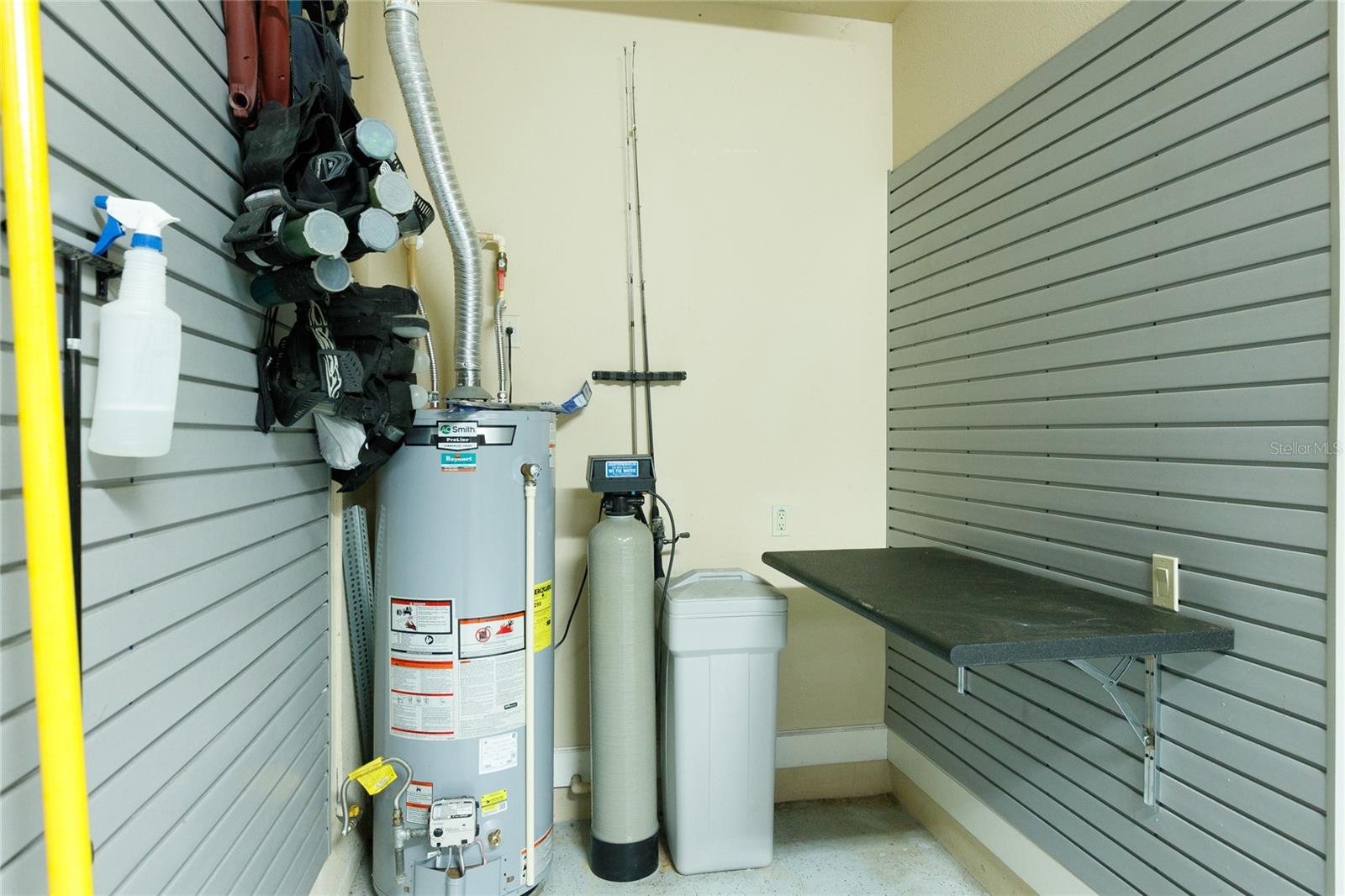 Wall slats, work bench and water softener in 3 car garage
