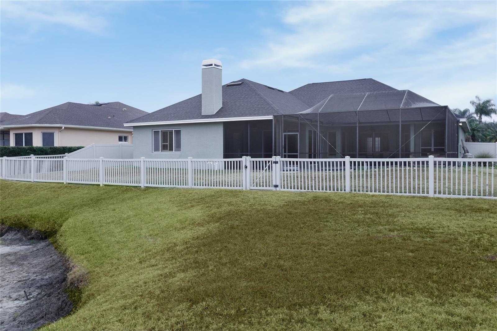 Rear view of vinyl fenced in yard