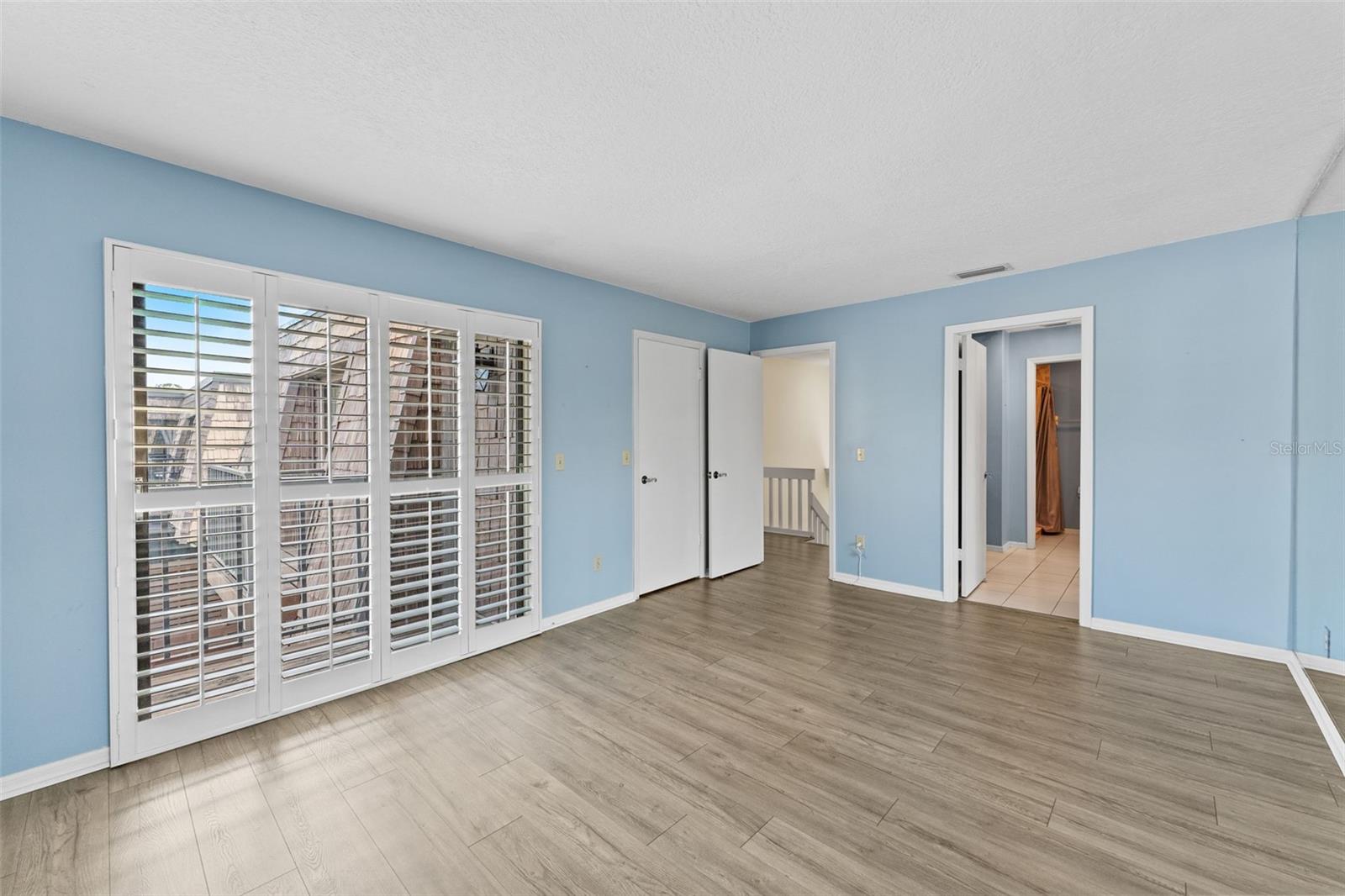 Primary Bedroom with balcony overlooking pond.