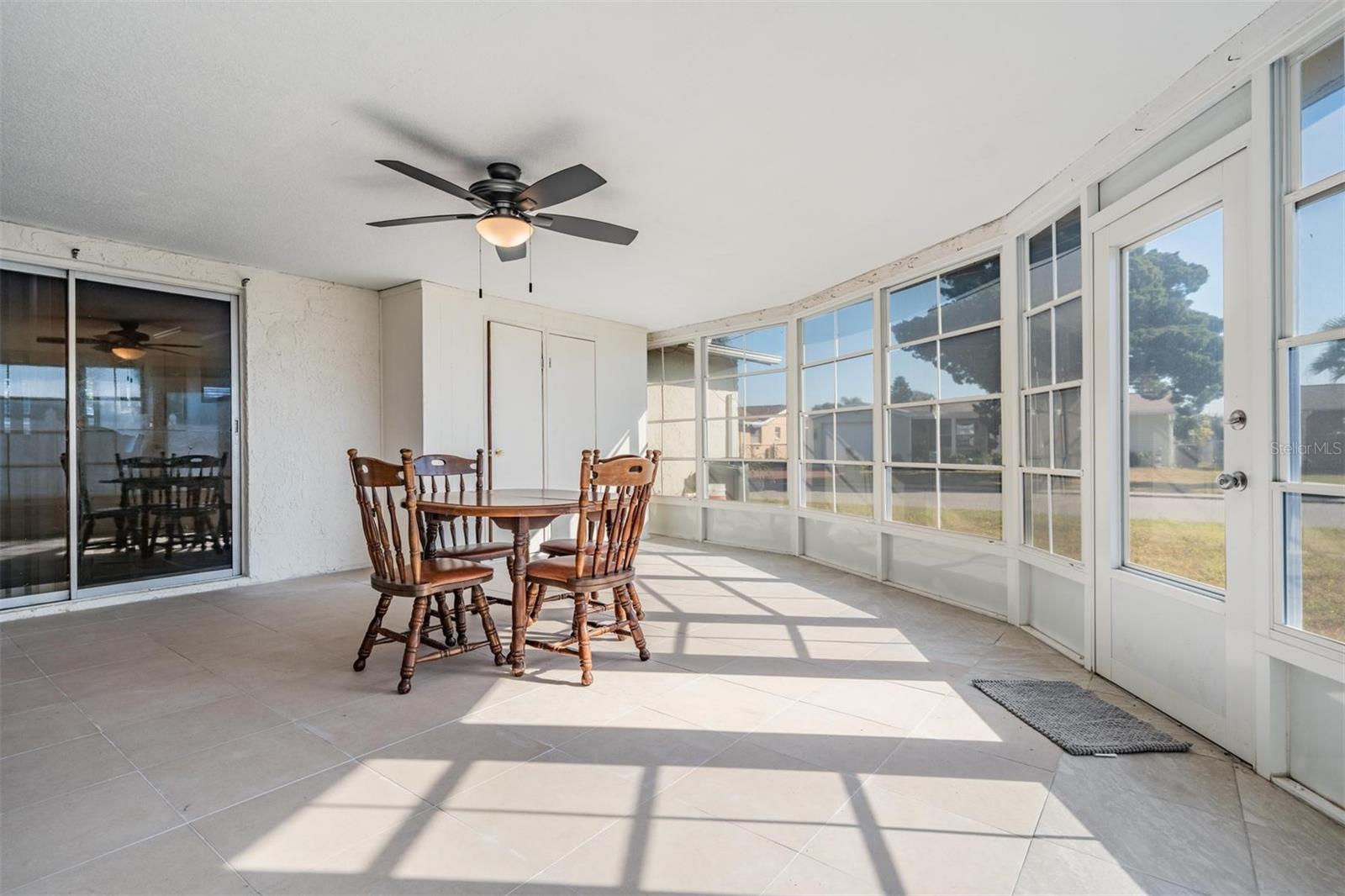 Enormous enclosed room with 2 closets. 1 closet has cedar siding. With slider windows and an exterior door.