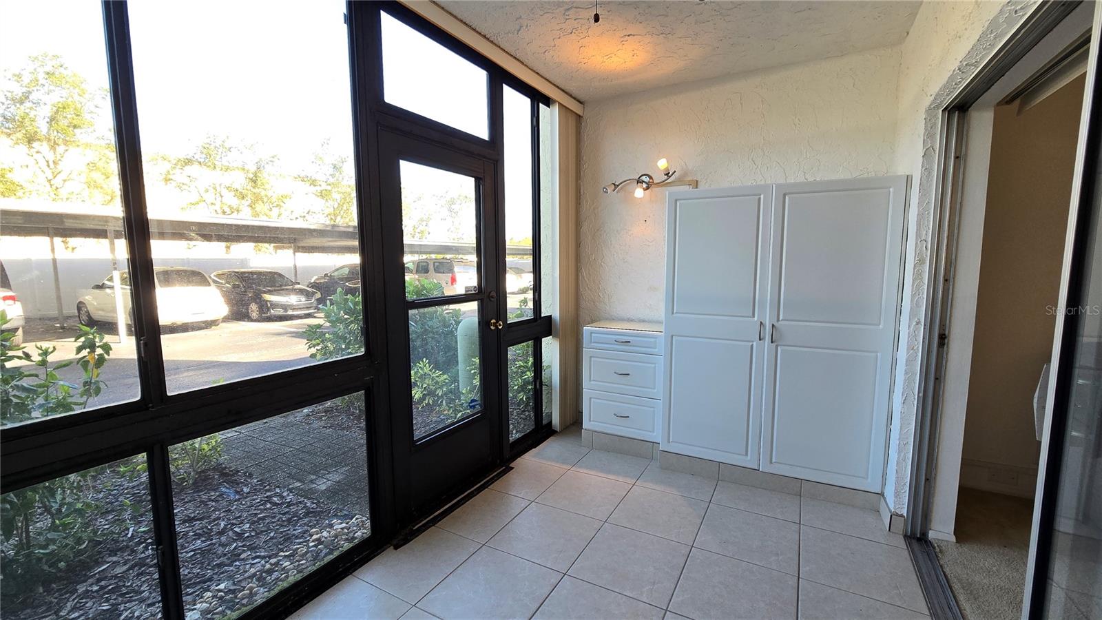 Large windows and rear access in the enclosed patio/porch.