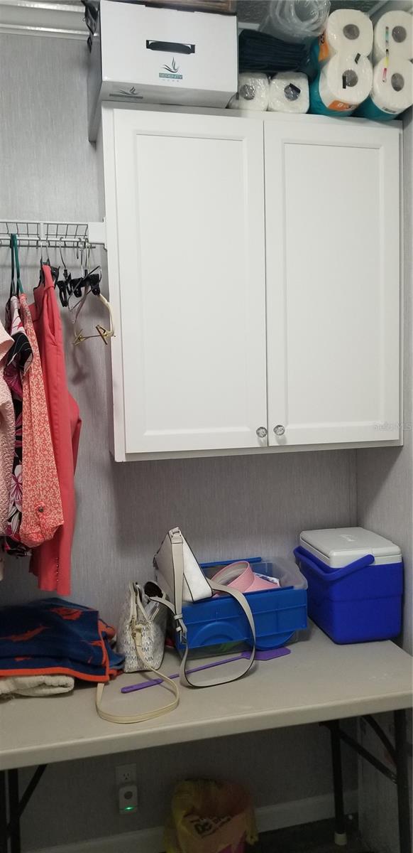 Inside laundry with storage