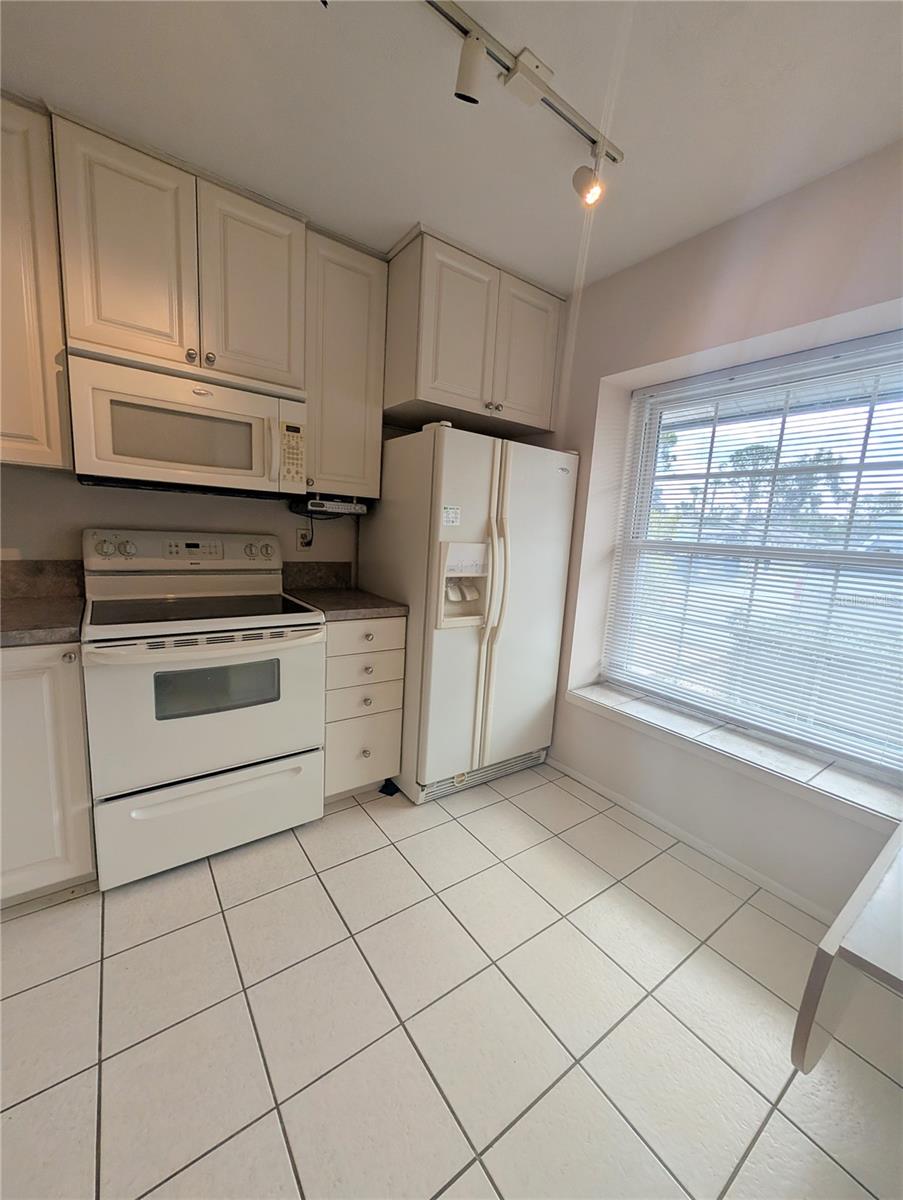 Clean and bright spacious kitchen with built in dining/work table