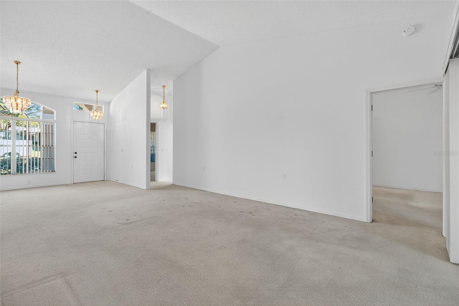 Living room showing the entry to the primary bedroom.