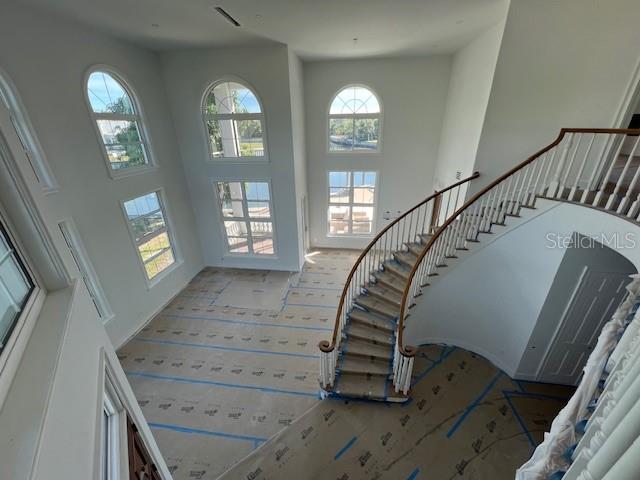 Soaring ceilings with sweeping staircase