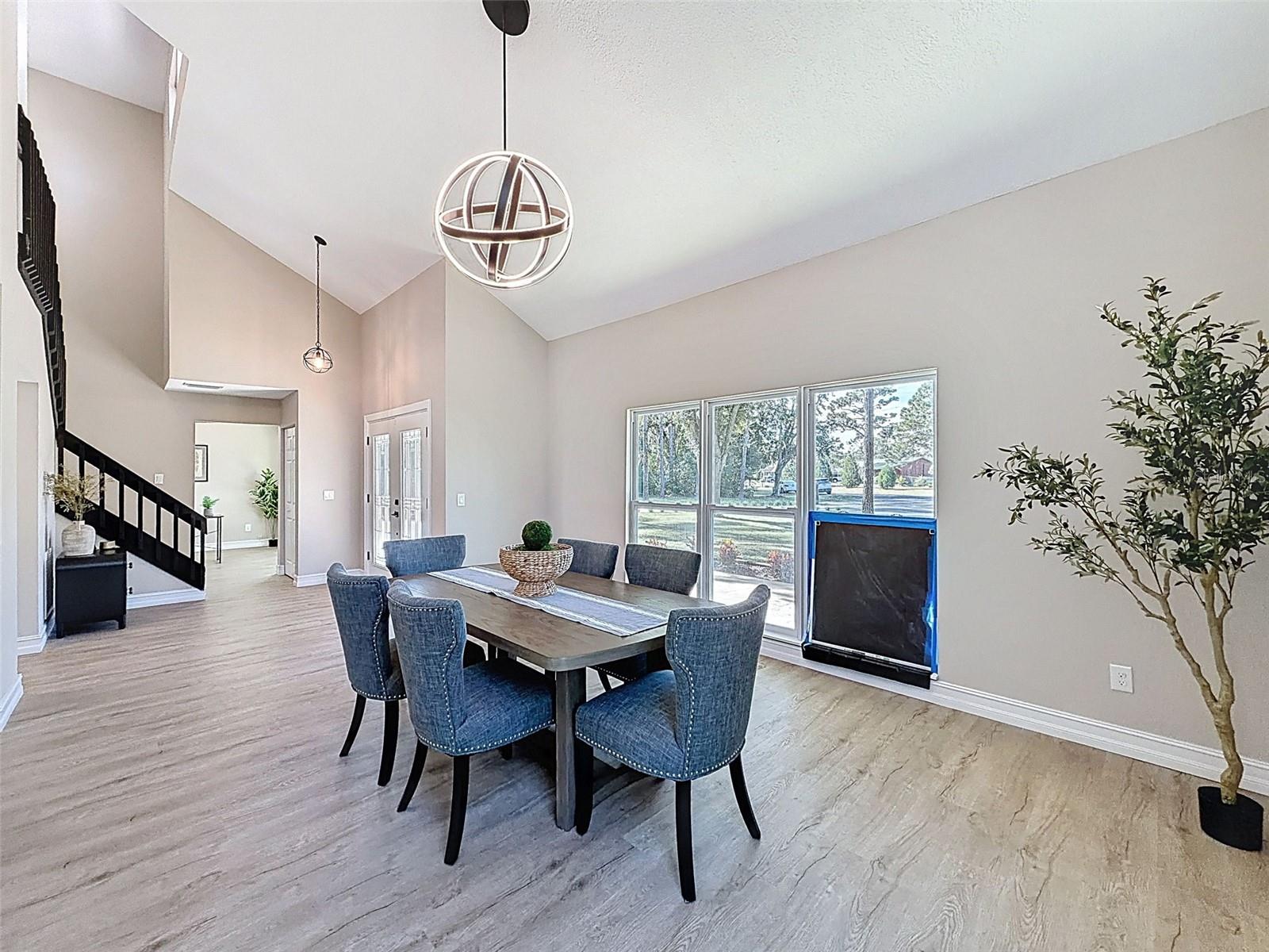 Staged as a huge dining room, but equally fitting as an extended living room. (Window replacement in the works.)