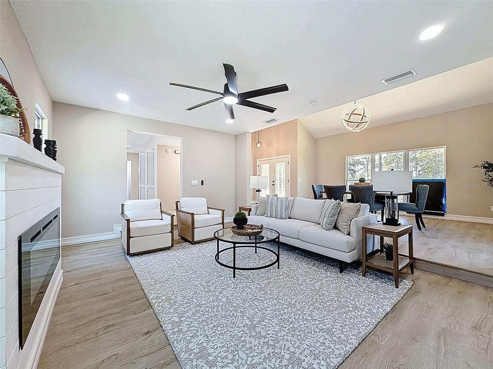 Spacious living room with electric fireplace.